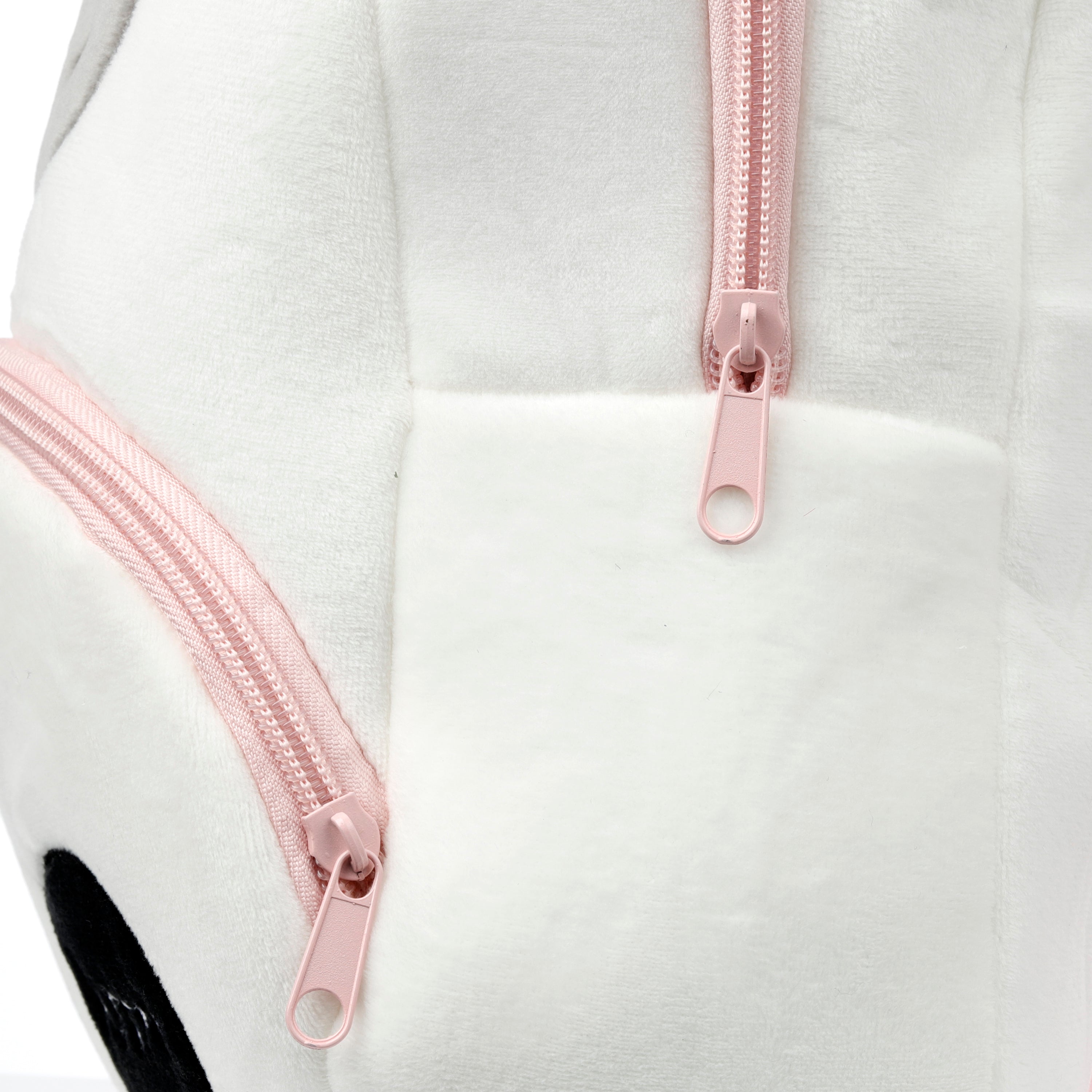 Close-up of the pink zip and soft white plush fabric on Astra unicorn bag.