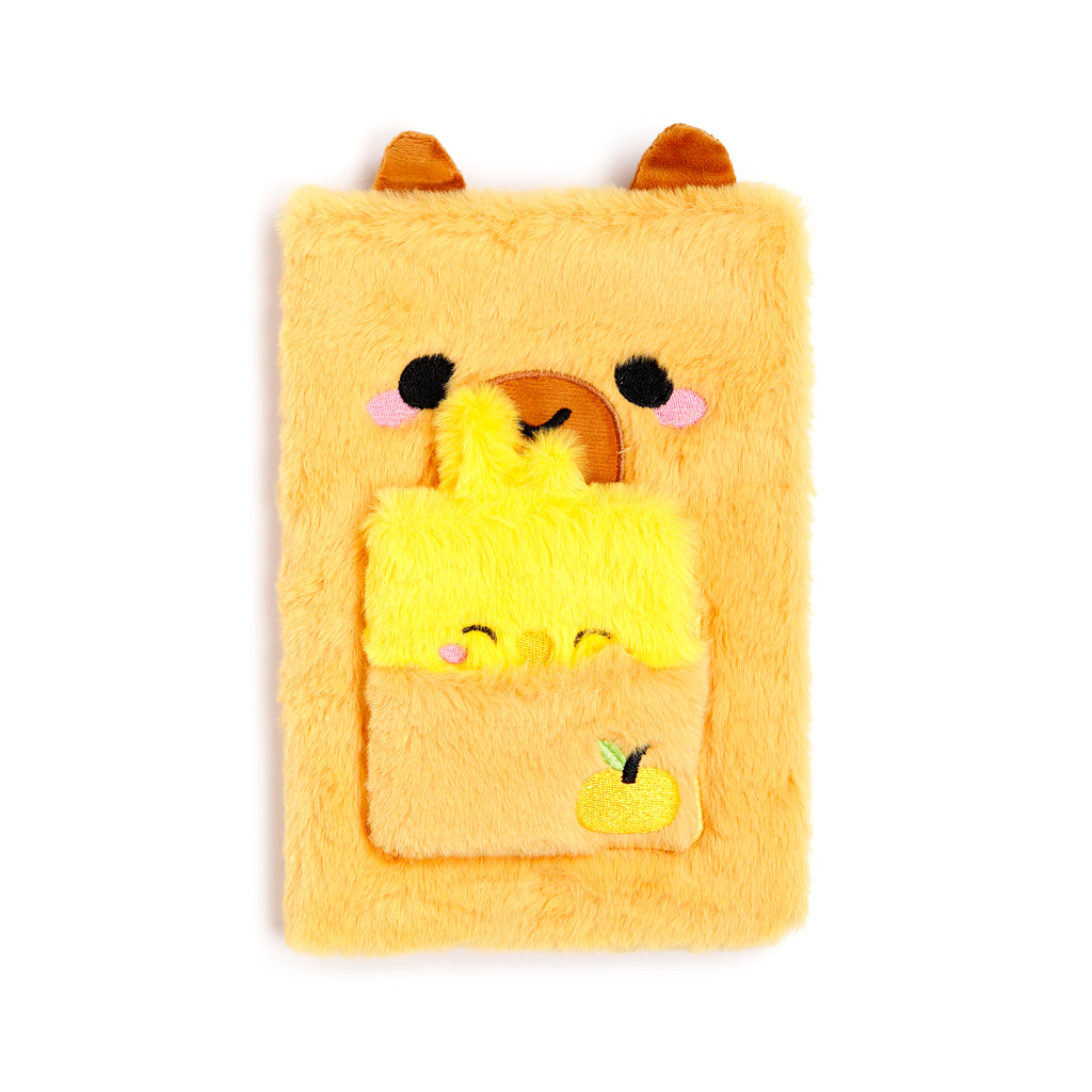 A soft, fuzzy brown capybara notebook with 3D ears and a small winking face, shown with a matching mini notebook stored in its plush belly pocket.