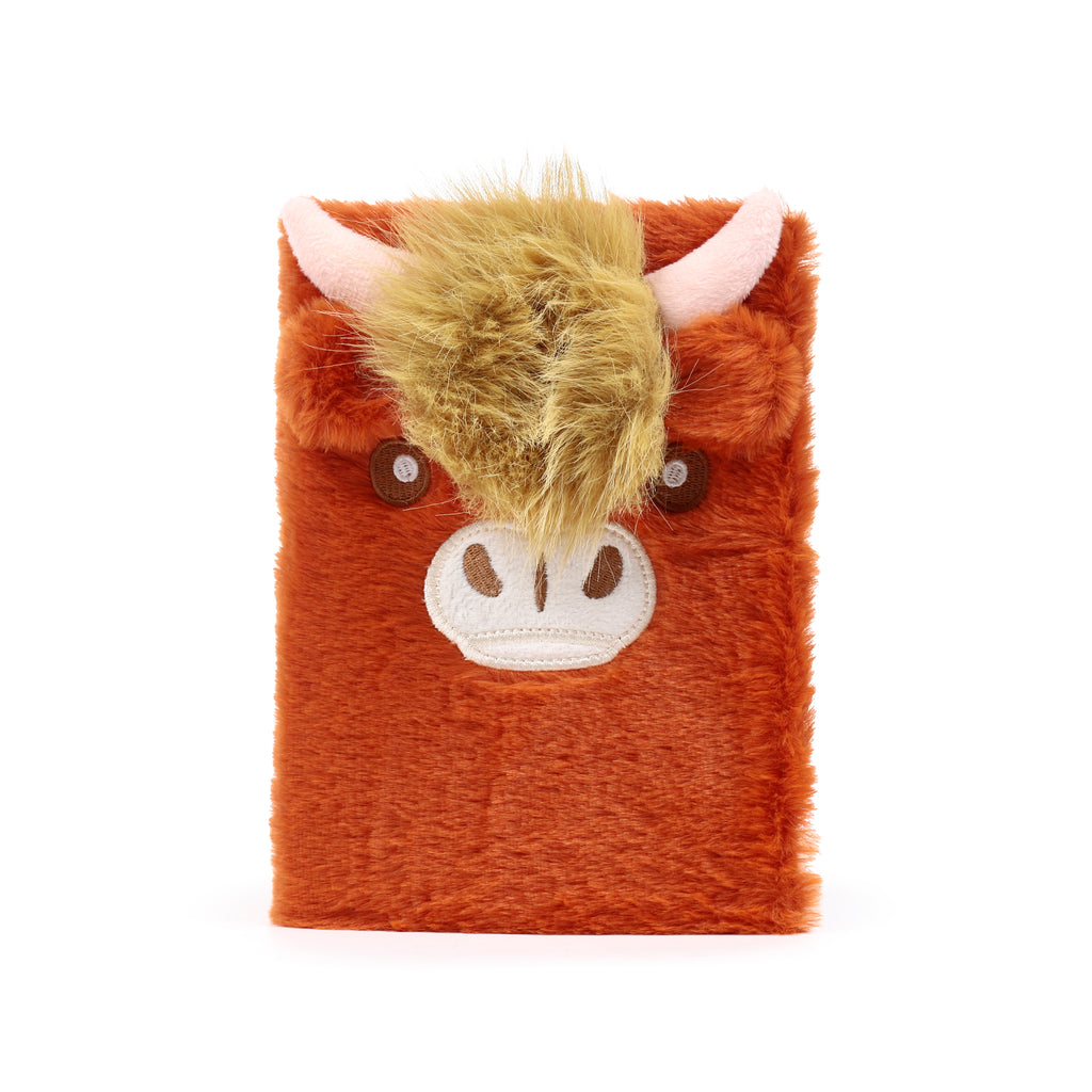 Front view of a shaggy ginger Highland Cow notebook featuring long-pile faux fur, an embroidered winking face, and soft plush horns.