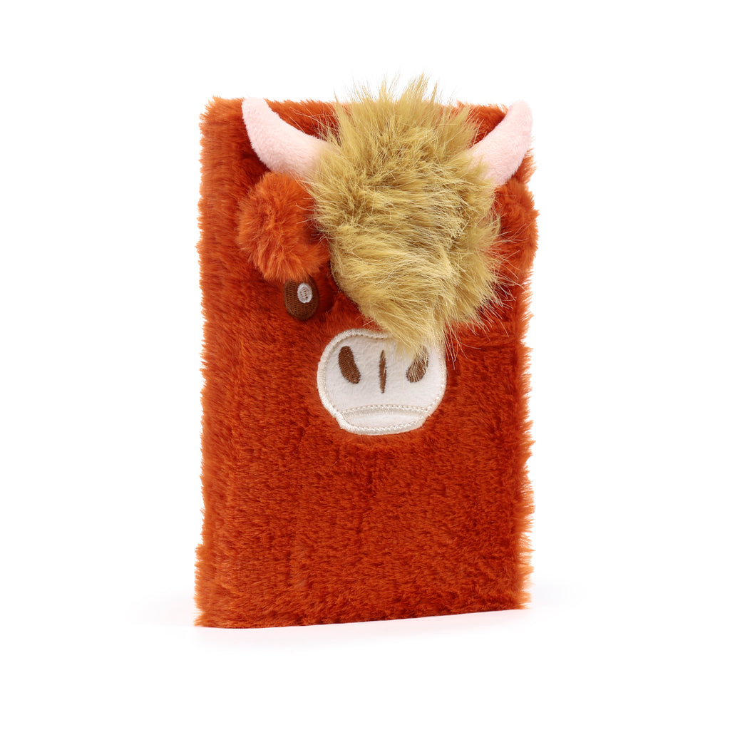 Fuzzy Highland Coo Cow plush notebook with shaggy orange fur, 3D ears, and small horns left.