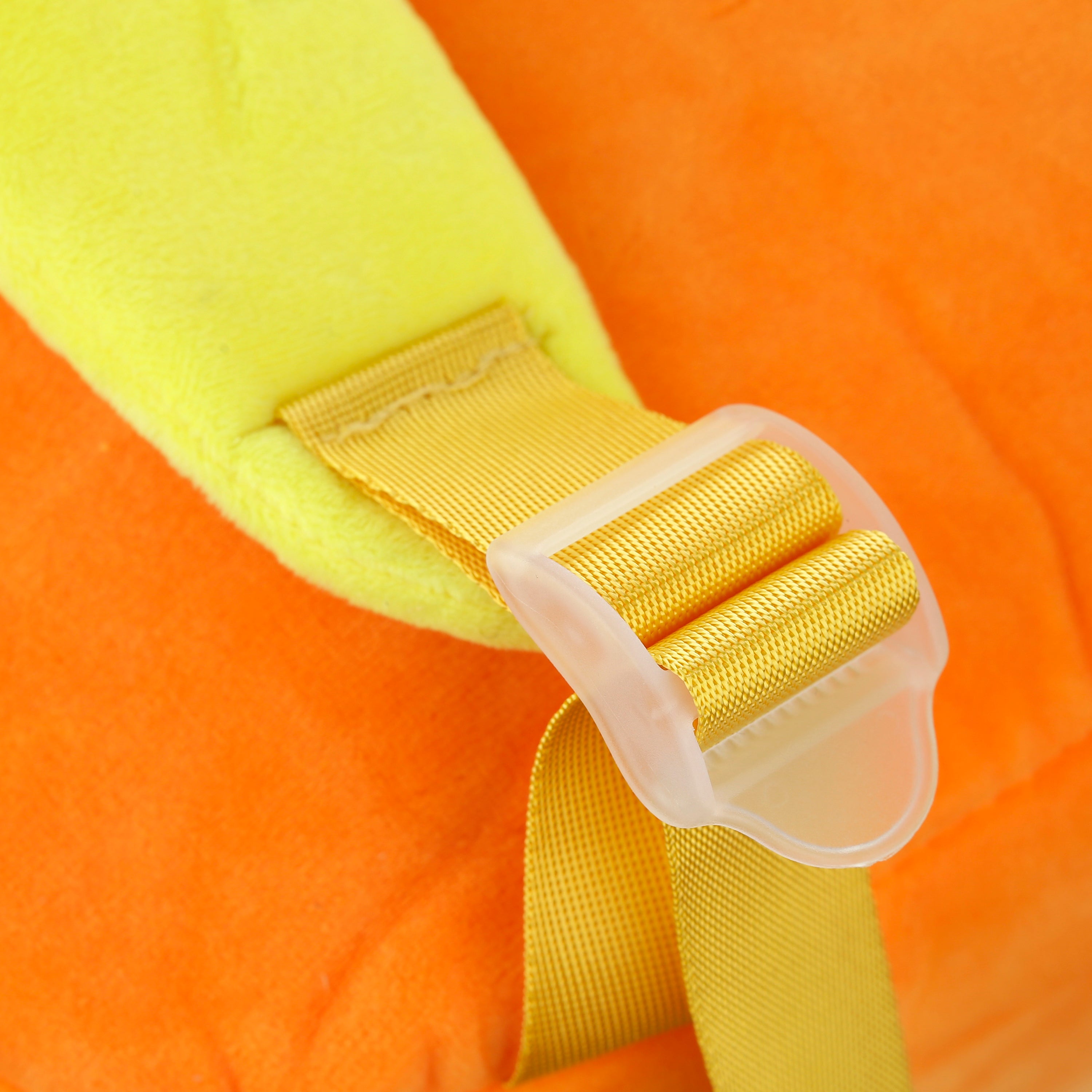 Close-up of a yellow strap with a clip on an orange fabric plush.