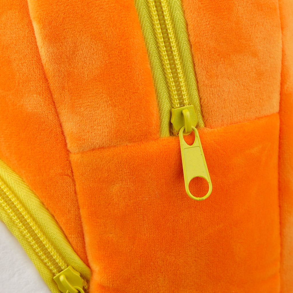 Close-up of the bright yellow zippers and soft orange plush fabric.