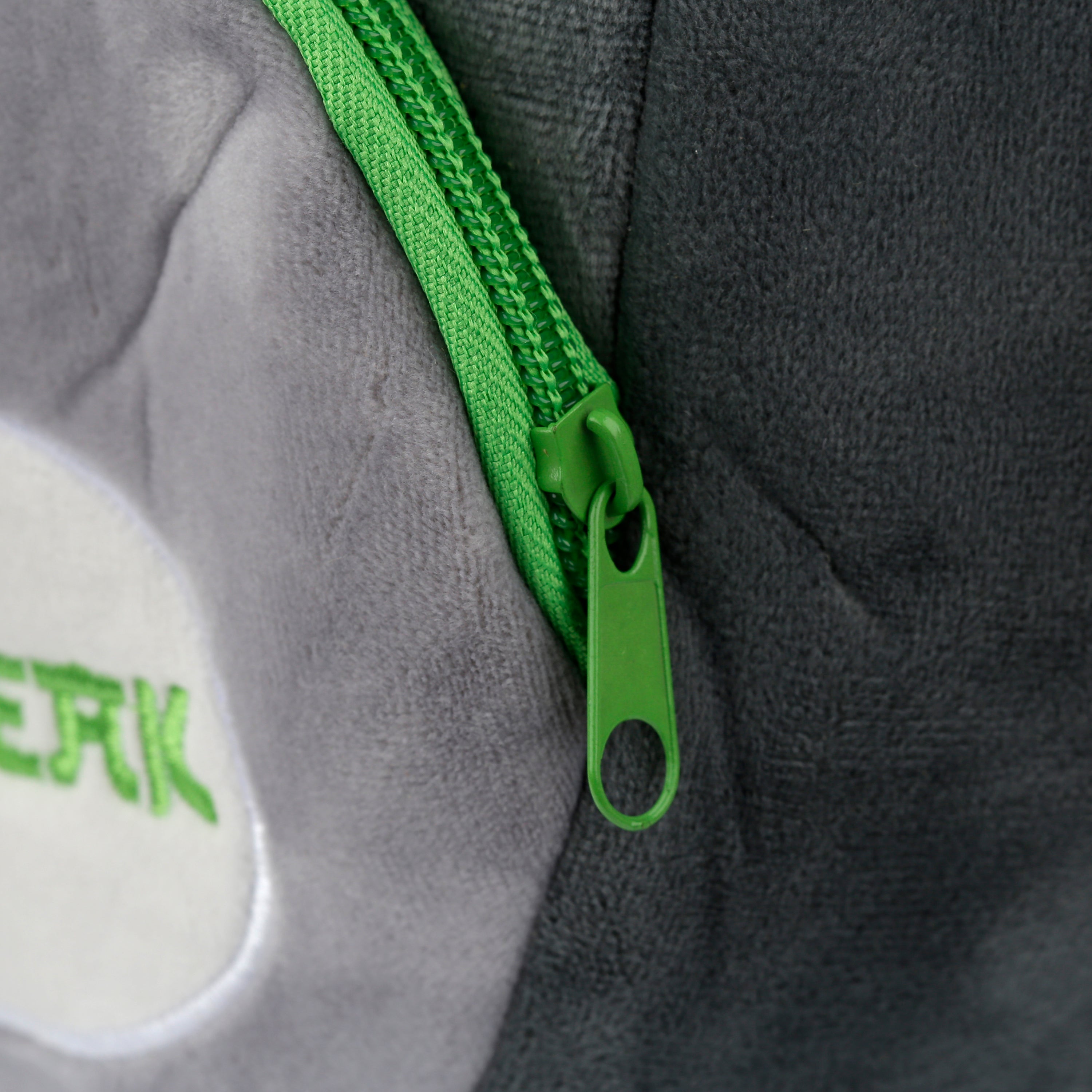 Close-up of the bright lime green zippers and SQUEAK detail on koala bag.